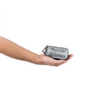 Hand holding a small gray backpack with 'Sea to Summit' branding on a white background