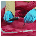 Person brushing seamgrip WP with a small brush on to a red waterproof jacket while wearing blue gloves.