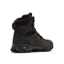 The image shows Columbia Mens GeoTerra OutDry Leather Hiking Boot in dark green and black with red lace accents, rugged sole, high ankle support, Columbia branding, a yellow Vibram logo, and waterproof construction—viewed from the rear side.
