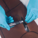 Person applying Aquaseal+FD to a tear in a brown jacket.