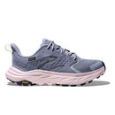 The Hoka Womens Anacapa 2 Low GORE-TEX Hiking Shoe features a light purple and gray mesh upper, black laces, and a thick pale pink sole with a yellow Vibram logo near the heel.