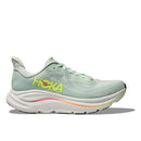 The Womens Clifton 10 Wide Running Shoe by Hoka is displayed in light green with a thick white sole, yellow HOKA logo, and orange-pink accents, shown in side profile on a white background.