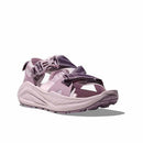 The Womens Infini Hike TC Trail Sandal by Hoka is a purple open-toe sandal with adjustable straps, a thick cushioned sole, and rugged tread, shown against a white background.