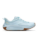 A chunky, brown-textured sole pairs with airy mesh and synthetic uppers in a light blue shade on the Hoka Womens Transport 2. Featuring a lace-up closure and HOKA branding near the heel, these sustainable city-to-trail sneakers are designed to deliver versatile comfort and reliable performance wherever you go.