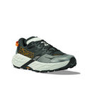 The Mens Speedgoat 7 Trail Running Shoe by Hoka features a thick, textured white sole, dark gray and black upper with orange accents, mesh panels for breathability—delivering comfort and style. Shown on a white background.