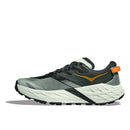 The Mens Speedgoat 7 Trail Running Shoe by Hoka is shown in profile, featuring a gray and black design with orange accents, a white cushioned sole, and a textured tread on a white background.