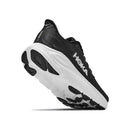 A Hoka Womens Clifton 11 Running Shoe in black with a thick white sole is shown from the back and side against a white background. Known as one of the most cushioned running shoes, this daily trainer delivers outstanding comfort and support for everyday runs.
