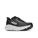A black Women’s Clifton 11 Running Shoe from Hoka, designed with a thick white sole and bold white HOKA logo on the side, is displayed against a plain white background. Ideal for everyday training, this cushioned running shoe delivers exceptional comfort and support with every step.