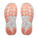 Two white athletic shoe soles with coral-colored tread patterns, viewed from the bottom. The design showcases geometric shapes and textured zones for enhanced grip, highlighting the advanced engineering of cushioned running shoes like the Hoka Womens Clifton 11 Running Shoe.