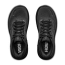 Top view of a pair of Mens Clifton 11 Wide Running Shoes by Hoka in black, featuring black laces and visible white Hoka logos on the insoles. The engineered mesh upper provides enhanced breathability, all set against a white background.
