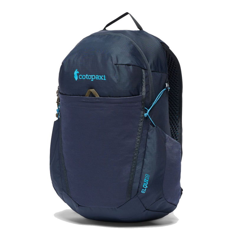 A Cotopaxi Elqui 18L Backpack in dark blue, featuring a front zipper pocket, mesh side pocket, and blue accents, stands upright against a white background. This backpack, made from recycled nylon, is an ideal hiking daypack for outdoor adventures.