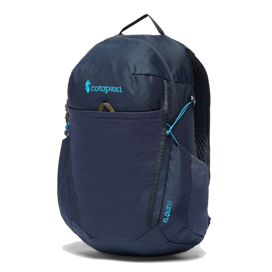 A Cotopaxi Elqui 18L Backpack in dark blue, featuring a front zipper pocket, mesh side pocket, and blue accents, stands upright against a white background. This backpack, made from recycled nylon, is an ideal hiking daypack for outdoor adventures.