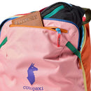 A pink Cotopaxi Allpa 28L Travel Pack - Del Día, made from sustainably sourced colorful fabrics and zippers, with a brown passport holder partially visible in the front pocket.