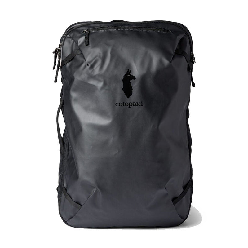 A Cotopaxi Allpa 35L Travel Pack in black stands upright against a white background, showcasing the brand’s minimalist llama logo, zippered compartments, and durable construction from recycled fabrics.