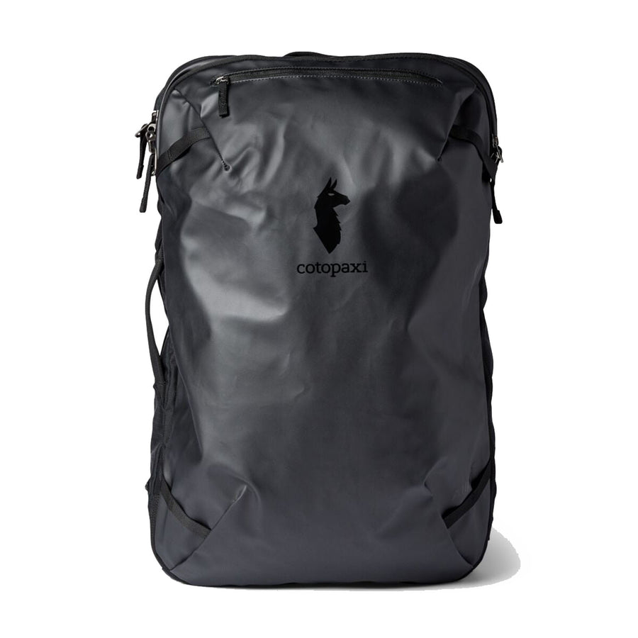 A Cotopaxi Allpa 35L Travel Pack in black stands upright against a white background, showcasing the brand’s minimalist llama logo, zippered compartments, and durable construction from recycled fabrics.