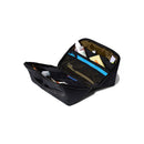 The Cotopaxi Viaje Toiletry Kit – Cada Día is a black toiletry bag made from recycled fabric, featuring multiple compartments and unzipping to reveal travel essentials like a toothbrush, toothpaste, lotion, and other personal care products.