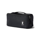 A black rectangular Cotopaxi Viaje Toiletry Kit - Cada Día, crafted from recycled fabric, features a top handle, zipper closure, and a distinctive Cotopaxi logo patch on the front—perfect for organizing your travel essentials.
