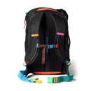 A Cotopaxi Allpa 35L Travel Pack - Del Día Dark in black, featuring colorful straps and accents in orange, blue, green, yellow, and pink. Viewed from the back, it displays padded shoulder straps and a label reading GEAR FOR GOOD, highlighting its sustainable design.