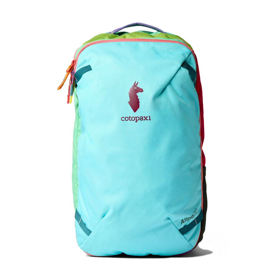 A Cotopaxi Allpa Mini 20L Travel Pack - Del Día is shown against a white background, featuring a turquoise body, a red llama logo, orange zipper pull, and a green side panel. This suitcase-style backpack combines vibrant design with versatile functionality.