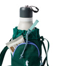 Green drawstring bottle bag with a water bottle, snack package, and blue strap on a white background