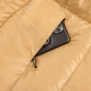 A smartphone partially tucked into a zippered pocket of a tan-colored puffy jacket, reminiscent of the cozy protection offered by the Sea to Summit Circuit Down Sleeping Bag (-1°C).
