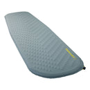 The Therm-a-Rest Trail Lite Sleeping Pad is a gray, self-inflating pad with a textured surface and rounded corners, featuring the yellow Therm-a-Rest logo near an air valve at one end. It is designed as a reliable three-season sleeping pad for lightweight backpacking adventures.