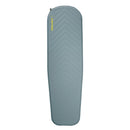 A light blue, rectangular Therm-a-Rest Trail Lite Sleeping Pad with slightly tapered sides and a textured surface, featuring a valve at the top left corner and the brand name “Therm-a-Rest” in yellow text near the top.