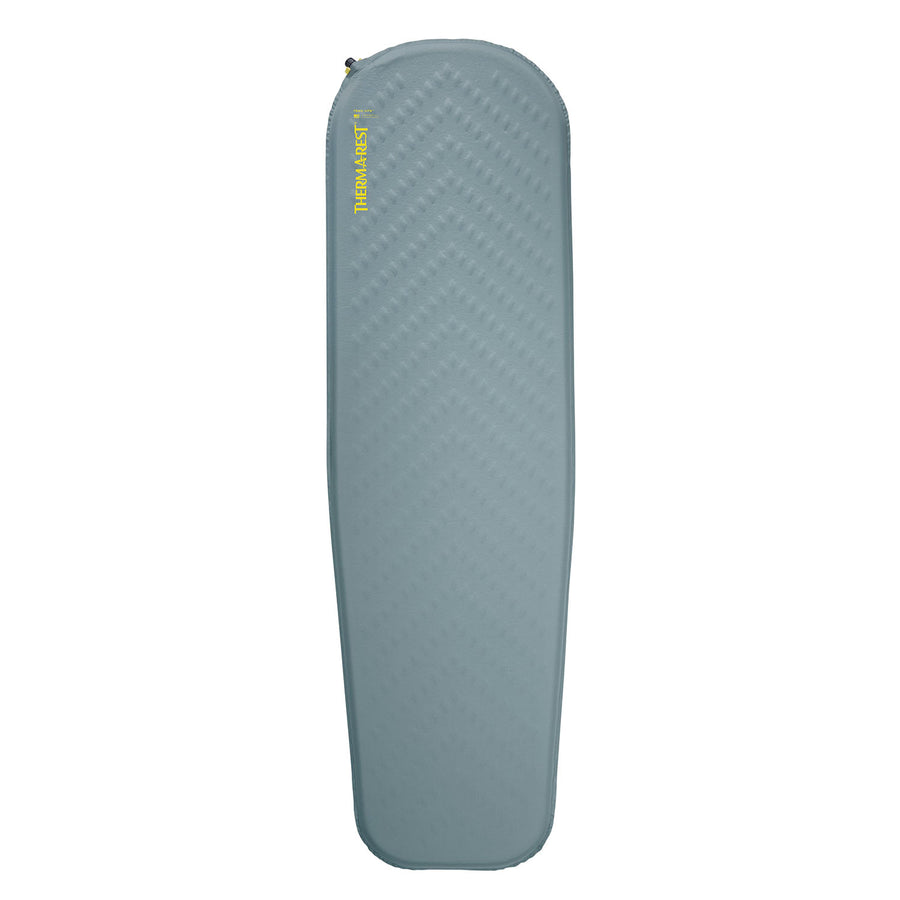 A light blue, rectangular Therm-a-Rest Trail Lite Sleeping Pad with slightly tapered sides and a textured surface, featuring a valve at the top left corner and the brand name “Therm-a-Rest” in yellow text near the top.