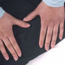 Close-up of two hands on a black waterproof jacket surface with a light rip visible.