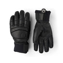 A pair of black insulated winter gloves, such as the Hestra Men’s Fall Line Glove, featuring reinforcement on the knuckles and wrist straps, displayed flat with one glove palm up and the other palm down on a white background—ideal cold weather skiing gloves.