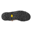 A rugged, angular tread pattern is featured on the black outsole of the Salewa Men’s Alp Trainer 2 Mid GORE-TEX Hiking Boot, with a yellow oval logo centered on the sole. Seen from directly below against a white background, this view emphasizes the durable craftsmanship and mountain-ready design of this waterproof boot.