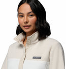 A woman with shoulder-length dark hair wears the Columbia Womens Benton Springs™ Half Snap Pullover, buttoned at the collar, against a plain white background.