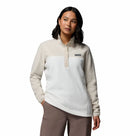 A woman with shoulder-length dark hair wears the Columbia Womens Benton Springs™ Half Snap Pullover in light beige and white, paired with brown pants, standing against a plain white background.