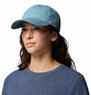 A person wearing a light blue Columbia Provisions Ball Cap with an adjustable back closure and a blue shirt, looking slightly to the side against a white background.