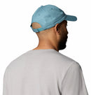 A man is shown from behind against a white background, wearing a light blue Columbia Provisions Ball Cap with an adjustable back closure and a light gray shirt.