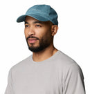 A man with a beard wears the Columbia Provisions Ball Cap in light blue, featuring an adjustable back closure, along with a light gray t-shirt, as he looks slightly to the side against a white background.