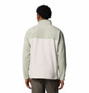 A person is shown from the back wearing a light-colored, two-tone Columbia Mens Steens Mountain™ II Half Snap Fleece with a high collar and PFAS-free fabric, paired with dark pants—an ideal choice for everyday use.