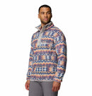 A man wearing the Columbia Mens Helvetia II Printed Half Snap Fleece with a high collar and snap buttons stands against a plain white background, looking slightly to his left.