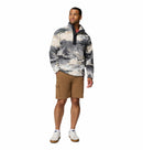 A man wears the Columbia Mens Helvetia II Printed Half Snap Fleece in gray and white, tan cargo shorts, and white sneakers with blue accents, standing against a plain white background.