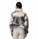 A person with brown hair in a ponytail is shown from the back wearing Columbia’s Women’s Helvetia II Cropped Sherpa Half Snap Printed Fleece and light beige pants against a plain white background.