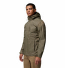 A man wearing a Columbia Mens Pouring Adventure™ III Waterproof Hiking Jacket in olive green and tan pants stands turned slightly to the side against a plain white background.