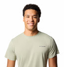 A young man with short curly hair smiles wearing a Columbia Mens Zero Rules™ Light Technical T-Shirt, featuring moisture-wicking fabric, against a plain white background.