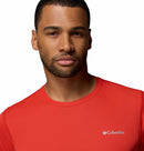A man in a bright red Columbia Mens Zero Rules™ Light Technical T-Shirt, featuring the logo on the chest and cooling technology, gazes neutrally at the camera against a plain white background.