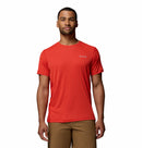 A man wearing a bright red Columbia Mens Zero Rules™ Light Technical T-Shirt and light brown shorts stands facing forward against a white background.