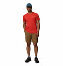 A man stands against a white background wearing a blue cap, Columbia Mens Zero Rules™ Light Technical T-Shirt, brown shorts, gray socks, and black hiking shoes. One hand is in his pocket and he has a relaxed expression.
