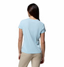 A woman with long brown hair is seen from the back, wearing the Columbia Womens Zero Rules Light Technical T-shirt in light blue and beige pants, standing against a white background.