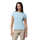 A woman faces the camera wearing the Columbia Womens Zero Rules Light Technical T-shirt in light blue and beige pants, set against a plain white background—ideal for hiking.