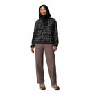 A woman faces forward with a neutral expression, wearing the Columbia Womens Sequoia Grove™ Printed Half Zip Fleece, taupe pants, and tan hiking shoes against a plain white background.