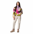 A woman faces forward in a Columbia Womens Sequoia Grove™ Printed Half Zip Fleece, paired with light pants and tan hiking boots against a white background.