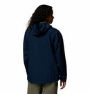 A person with long, curly hair faces away, wearing the Columbia Womens Trailborne 2.5L Waterproof Shell Jacket in navy and light-colored pants against a plain white background.